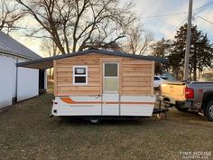 a tiny house is parked in the yard