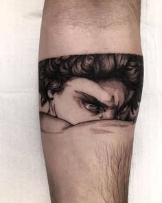 a man's arm with a black and white image of a woman on it