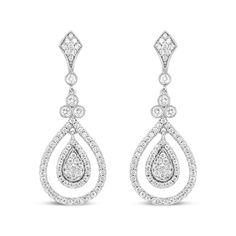 Let the sparkle of diamonds enhance your every look! Glimmering prong-set round diamonds adorn polished 18k white gold, giving you a stunning look of sophistication. These diamonds total 1 1/4 cttw with an approximate F-G Color and VS1-VS2 Clarity. The silhouette features an intricate upper dangle set with diamonds clusters above a single round diamond encases in a secure bezel setting with milgrain detail. Beginning the lower dangle is a trio of round white diamonds that signify the past, present, and future, which are also showcases in bezel settings with milgrain ornamentation. A cluster of round, prong-set diamonds form a teardrop silhouette haloed by additional round, prong-set diamonds. A metal framework prong-set with round diamonds adds a second halo to this centerpiece that captur Stylish Watches, Diamond Cluster, Gold Material, Bezel Setting, Earings Piercings, Diamond White, Round Diamond, Amazing Jewelry, Prong Setting