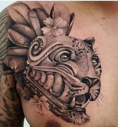 a man's chest with a tiger head and flowers on the top of it