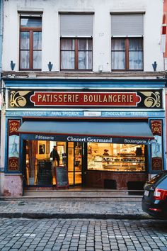 the storefront of patisserie boulangerie in paris, france is painted blue and red