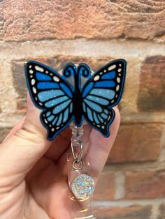 "Beautiful glittered blue butterfly badge reel! PRODUCT INFO:  - 2\" Acrylic Blank -Most acrylics have been done with sublimation ink, sometimes it may be permanent vinyl -Most acrylics have been hand glittered on the back side and sealed with UV resin for extra protection. Some badge reels DO NOT have glitter.  - Acrylics are glued onto the badge reel with E6000 glue -Choose between an alligator swivel clip (which you can clip to pockets, scrubs, or any other loose articles of clothing) or a be Cheap Customizable Blue Badge Reel, Butterfly Badge Reel, E6000 Glue, Resin Crafts Tutorial, Id Badge Reels, Medical Assistant, Glitter Acrylics, Sublimation Ink, Uv Resin