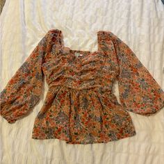 American Eagle Baby Doll Blouse Never Worn Size Small. Pretty Pink And Coral Colored Cute Floral Print Tops For Fall, Cute Long Sleeve Orange Top, Cute Long Sleeve Floral Print Tops, Cute Fall Blouse For Brunch, Cute Multicolor Long Sleeve Blouse, Cute Long Sleeve Red Blouse, Cute Red Long Sleeve Blouse, Spring Multicolor Square Neck Tops, Multicolor Square Neck Tops For Spring