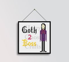 a cross - stitch sign hanging on a wall with the words goth and 2 boss's