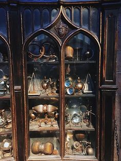 a display case filled with lots of different types of items on top of wooden shelves