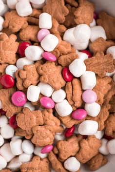 a bowl filled with lots of white and pink candies