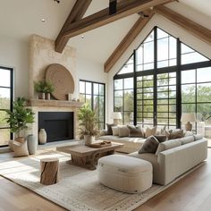 a living room filled with lots of furniture next to large windows on top of a hard wood floor