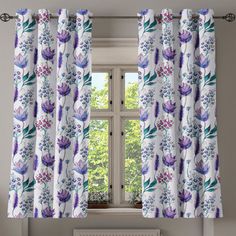 a window with floral curtains in front of it and a radiator on the side