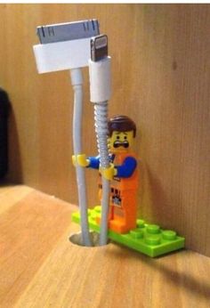 a lego man standing next to a toothbrush holder