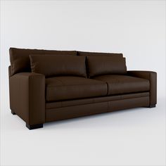 a brown leather couch sitting on top of a white floor