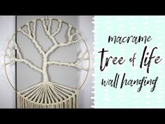 a macrame tree of life hanging on the wall with white circles around it