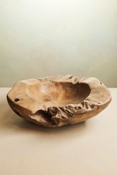 a wooden bowl sitting on top of a table