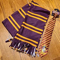 two harry potter scarves and a tie on the floor