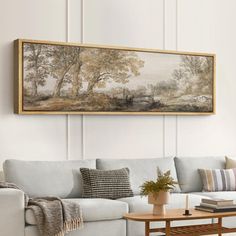 a living room with a couch, coffee table and painting on the wall above it