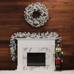 a fireplace with a wreath on top and a nutcracker statue next to it