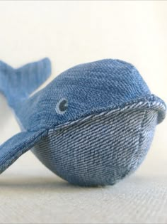 a small blue bird made out of jeans