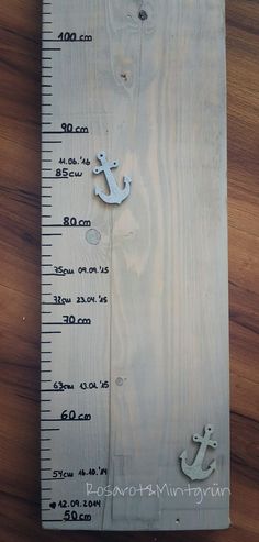 a wooden ruler with an anchor on it