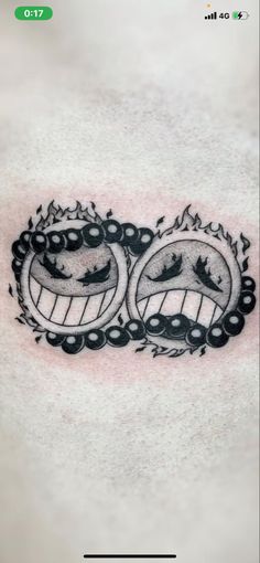 a black and white tattoo with two faces