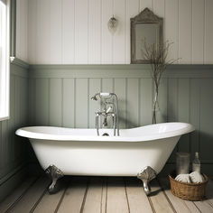 a white bath tub sitting in a bathroom next to a mirror and wooden flooring