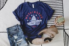 * 50% polyester, 25% combed ring-spun cotton, 25% rayon * Fabric weight: 3.4 oz/yd² (115.3 g/m²) * Pre-shrunk for extra durability * Regular fit * Side-seamed construction Patriotic Blue Cotton T-shirt, Blue Patriotic Cotton T-shirt, Washington Dc Capitol, Rayon Fabric, Washington Dc, Varsity Jacket, Fabric Weights, Spun Cotton, Gender Neutral