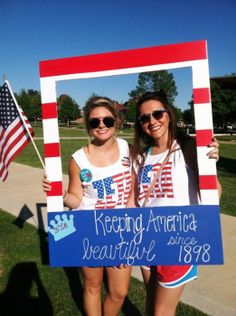 two girls holding up a sign that says keeping america beautiful since 1989 and an american flag