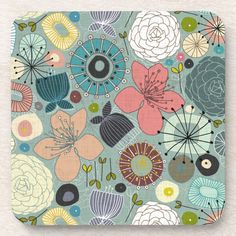 a square coaster with colorful flowers and leaves on the front, along with an abstract design