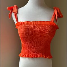 Adjustable Straps, Ties In A Bow, Bright Orange With Stretch Crop Top Trendy Tie Straps Tops For Vacation, Casual Vacation Top With Tie Straps, Casual Tie Straps Tops For Vacation, Casual Vacation Tops With Tie Straps, Casual Tops With Tie Straps For Vacation, Orange Sleeveless Top For Brunch, Casual Tops With Tie Straps And Stretch, Casual Stretch Top With Tie Straps, Casual Cropped Tops With Tie Straps