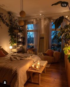 a bed room with a neatly made bed and two candles on the coffee table next to it