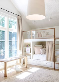 a bedroom with bunk beds and white furniture