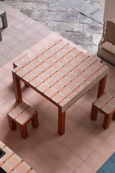 an outdoor table and bench made out of tiles