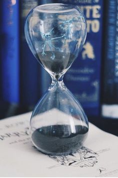 an hourglass sitting on top of a book