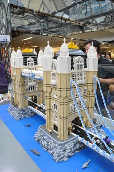 a model of a castle made out of legos on display at an indoor event