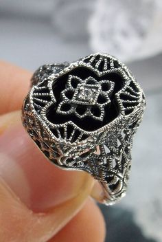 Black Camphor Glass & Cubic Zirconia Ring Cathedral Design#204 This is a lovely detailed and intricate Art Deco reproduction ring. This lovely filigree reproduction ring is handcrafted in sterling silver. The lovely black glass camphor stone is 11mm x 9mm. The face of the ring is 13.5mm North South and 10mm East West on the finger. Notice the 1.5mm center White CZ gemstone. The inside of the band is marked 925 for sterling silver. This is an exquisite rendition of an antique filigree ring. The i Filigree Diamond Ring, Art Deco Filigree, Stock Design, Antique Filigree, Antique Diamond Rings, Glass Ring, Gem Ring, Glass Rings, Silver Art