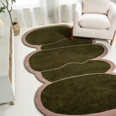 a living room with green rugs and a white chair