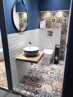 a bathroom with blue walls and white tiles on the floor is pictured in this image