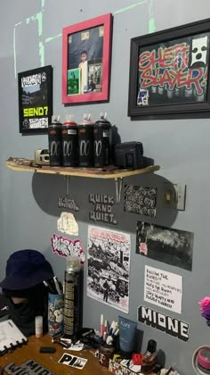 a skateboard mounted to the side of a wall above a wooden desk with various items on it