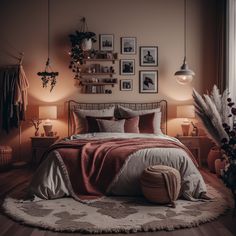 a bed sitting in a bedroom next to two lamps and pictures on the wall above it