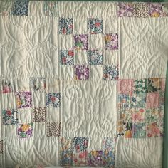 an old quilt is hanging on the wall