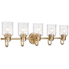 a bathroom light fixture with five lights on the side and four glass shades on the top