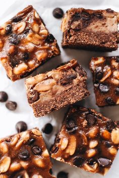 brownies with chocolate chips and nuts on a white plate