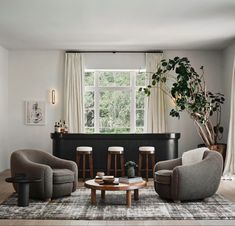 a living room filled with furniture and a large window