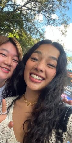 two young women giving the thumbs up sign