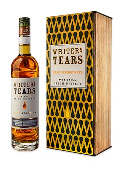 a bottle of writer's tears cask strength whisky next to a wooden box