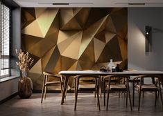 a dining room with a table and chairs in front of a geometric wallpaper design