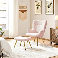 a pink chair and ottoman in a white room