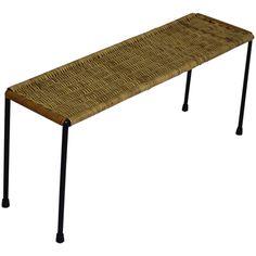 a bench made out of woven material with metal legs