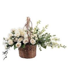 a basket filled with white flowers and greenery