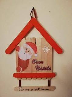 a wooden house with santa clause on it