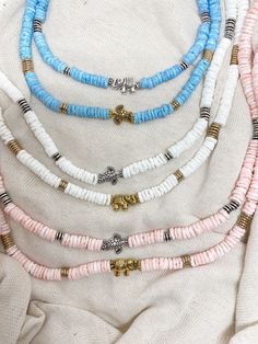 "Transport yourself to the sunny shores of Hawaii with our Puka Shell Choker Necklace, available in your choice of charming white, serene pink, or calming blue round cut chip shells. This necklace captures the essence of beachside relaxation, making it the perfect accessory for those who appreciate the laid-back surfer style and coastal vibes. Key Features: Round Cut Shells: The necklace features genuine round cut chip shells, available in three soothing colors: classic white, soft pink, or tran Tranquil Blue, Shell Choker, Beach Necklace, Coastal Vibes, Surfer Style, Surfer Necklace, Beach Necklaces, Puka Shell, Turtle Charm