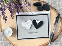 two heart shaped paper cutouts sitting on top of a card